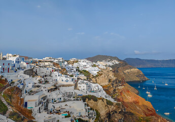 Fototapeta na wymiar Panoramic view of Oia village on Santorini island, Greece. Town with cycladic white houses located on the cliffs of the island.