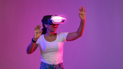 Immersive Adventures. Excited Black Female Using VR Glasses In Neon Light