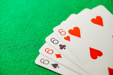 Playing cards, poker combination four of kind, quads, sixes of different suits, same value