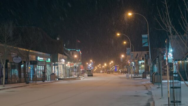 Beautiful Jasper town with snowfall and street light in downtown at night