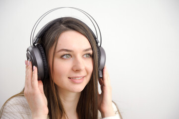 Fototapeta premium Happy woman dreaming listening music with phone headphone on white. High quality photo