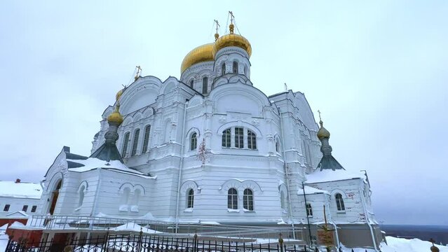 Belogorsky St. Nicholas Orthodox Missionary Monastery. Russia, Perm Krai, Belaya Gora. The temple on the hill in winter. Monastery on the background of snow. 4K
