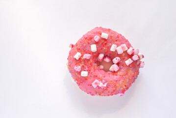 Pink donut with sprinkles isolated on white background