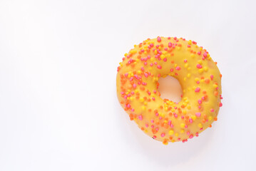 Yellow donut with sprinkles isolated on white background