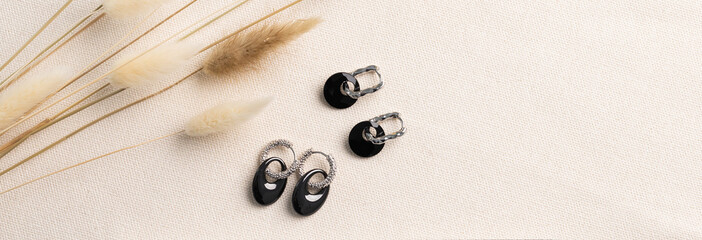 Banner Elegant jewelry set of silver earrings with gem. Jewelry set minimalist style copy space and...