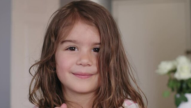 Close Up Portrait of Little 4 Year Old Girl Looking At Camera. 4K Footage.