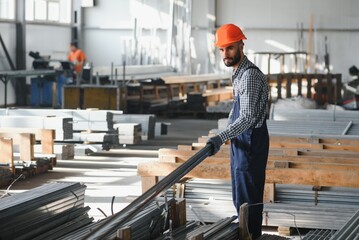 Factory worker measures the metal profile