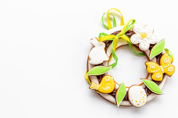 Easter sweet wreath made of bunny and eggs cookies, top view