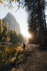 Fototapete Yosemite Merced River Sun Burst Man Standing Sunset Trees Forest © Dylan