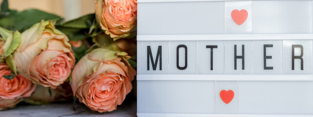 Fototapeta premium Happy Mother's Day.Lightbox with the word Happy Mother's Day next to flowers. Holiday card.