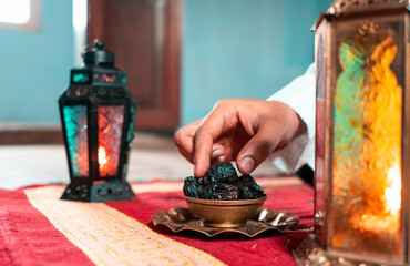 Iftar special image hand picking dates fruits