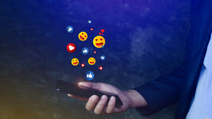 Social media and online digital concept, Businessman using smart phone sending emojis with social media.