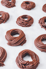 Cacao dough for cookies, dough in the shape of a circle or a nest on parchment paper. Preparing process to baking.