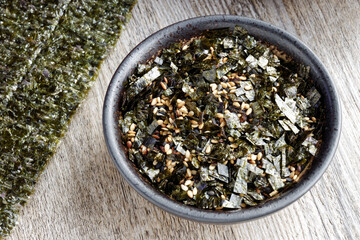 Obraz na płótnie Canvas Vegan furikake seasoning with torn nori seaweed. Japanese cuisine condiment in a bowl.