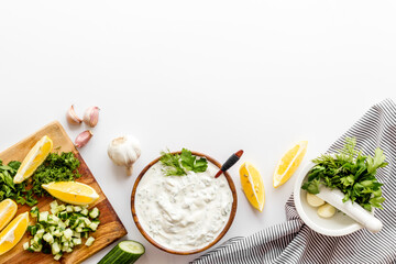 Homemade cooking of greek dip sauce sour cream with herbs and cucumber