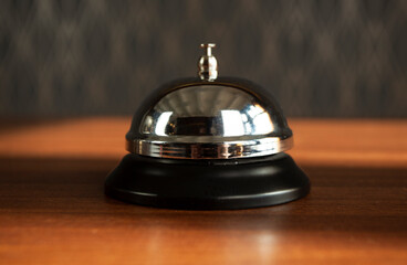 Service bell vintage with bokeh background. Hand ringing for call assistance on demand and services.