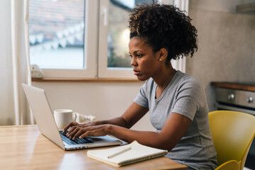 A woman works on her laptop