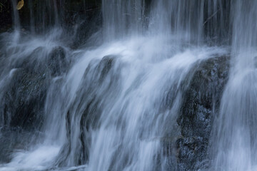 Fototapeta na wymiar Waterfall outdoors over rocks
