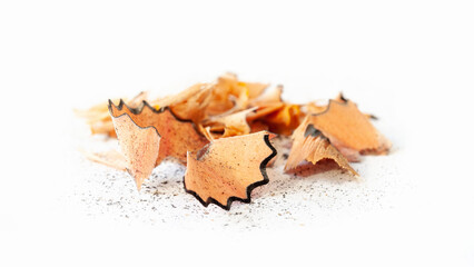 Shavings from a pencil. Wooden pencil shavings on white. Sharpening debris