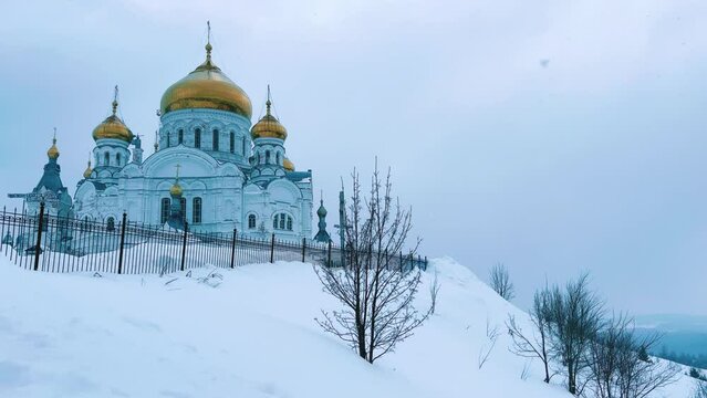 Belogorsky St. Nicholas Orthodox Missionary Monastery. Russia, Perm Krai, Belaya Gora. The temple on the hill in winter. Monastery on the background of snow. 4K