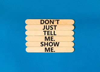 Tell or show symbol. Concept words Do not just tell me, show me on wooden stick. Beautiful blue...