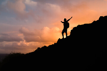 Hiker with arms up standing on the top of the mountain - Successful man enjoying triumph - Sport and success concept	