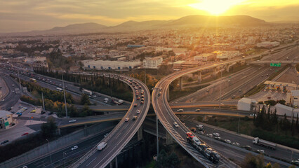 Fototapeta na wymiar Aerial drone photo of modern Attiki Odos toll multilevel interchange highway with National road in Attica area at sunset, Athens, Greece