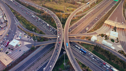 Aerial drone photo of modern Attiki Odos toll multilevel interchange highway with National road in Attica area at sunset, Athens, Greece
