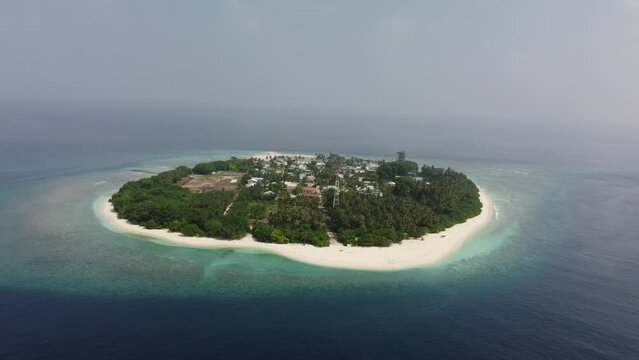 Tropical paradise with blue sea and green island in the maldives