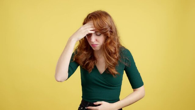 Redheaded woman gesturing bodily discomfort and headache