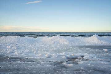 Fototapeta na wymiar Baltic Sea in Winter. Beautiful view of Ice and Snow along the coast.