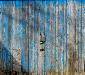 pastel wood wooden white blue with plank wall texture background giving a feeling of old and beautiful. Old blue door with a brass padlock