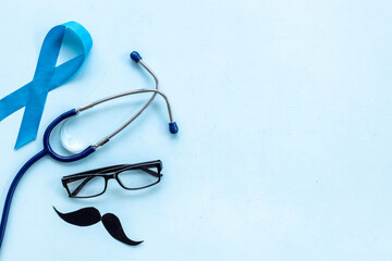 Blue ribbon prostate cancer awareness with stethoscope. Male medical checkup concept