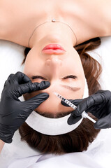 Botulinum therapy, Botox injection at cosmetology clinic. Method of wrinkle correction by local...