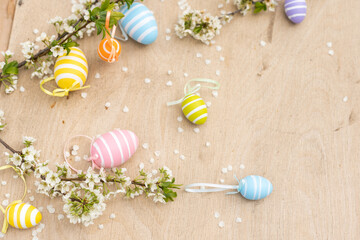 Happy Easter. Easter eggs on rustic table with cherry blossoms. Natural dyed colorful eggs and spring flowers. Countryside still life