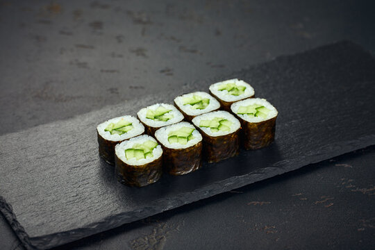 Roll with cucumber on dark background. Sushi menu. Japanese food.