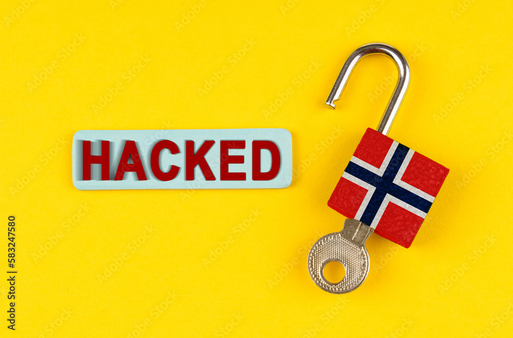 Poster on the yellow surface is an open lock with a key and a sticker with the inscription - hacked