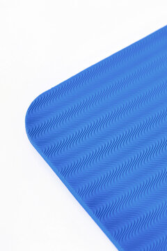 Corner of yoga mat on white background, closeup texture
