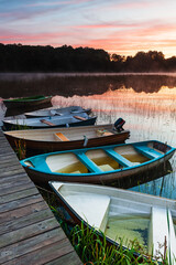 Row of boats at jetty during sunrise