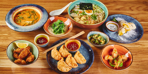 Fototapeta na wymiar Set of assorted pan asian dishes. Chinese, Korean, Japanese cuisine. Soups, dumplings, noodles, rice and desserts.