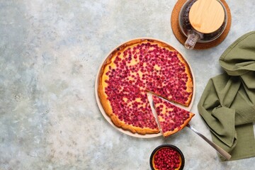 Open pie, shortcrust pastry tart stuffed with cranberries and sour cream filling on a ceramic plate on a gray concrete background. Recipes for pies, tarts.
