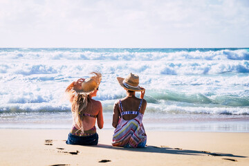 Young girls couple back view enjoy sun and tourism in summer holiday vacation together....