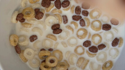 Macro close up cereal with milk and spoon. Morning breakfast food concept