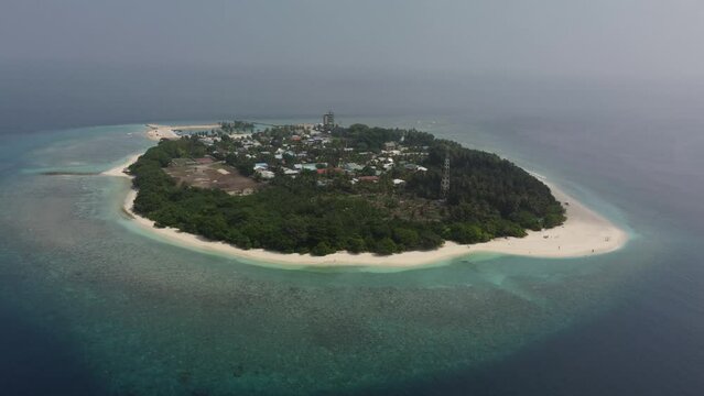 Tropical paradise with blue sea and green island in the maldives
