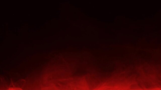 Red smoke on a dark background, slow motion.