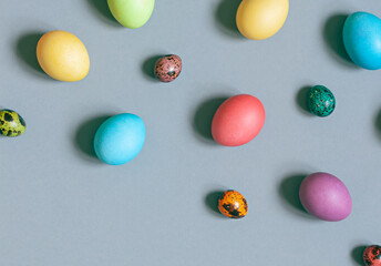 Colorful painted Easter eggs on the grey background. Top view. Copy space