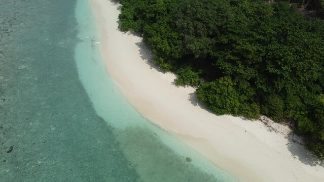 Tropical paradise with blue sea and green island in the maldives