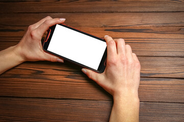 a phone with hands addiction on a wooden background