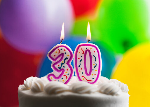 Number 30 Birthday Candles Against Colorful Balloon Background