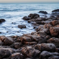 sea view with rocks in the foreground at dawn - generative ai